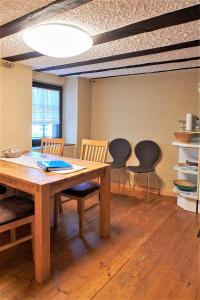a dining room with a table and three chairs at Mählich Haus in Manderscheid +3 photos