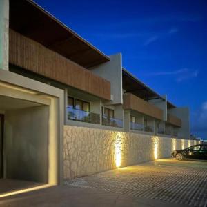 a building with a car parked in front of it at Kanui Milagres 112 in São Miguel dos Milagres