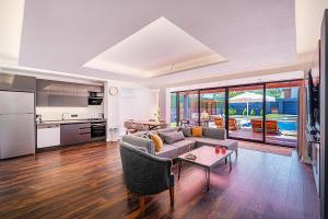 a living room with a couch and a table at Luxurylifevillas 5-6 in Fethiye