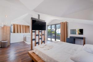 a bedroom with a large bed and a television at Luxurylifevillas 5-6 in Fethiye +27 photos