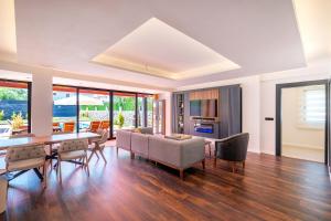 a dining room and living room with a table and chairs at Luxurylifevillas 5-6 in Fethiye