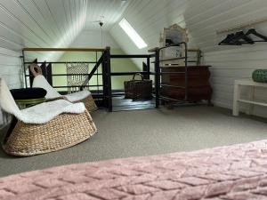 a attic room with a bed and a room with at Voel je thuis in Zwolle