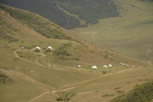 a group of tents on a grassy hill at Shatyly Lake ViewGlamping in Bokonbayevo