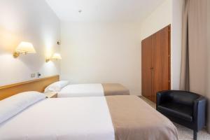 Postel nebo postele na pokoji v ubytování Hotel Leuka