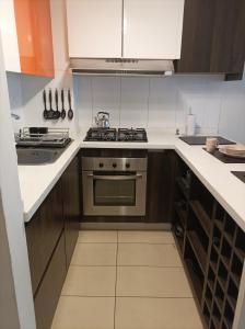 a kitchen with a stove and a sink at Depto. Full equipado in Iquique