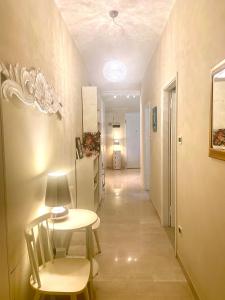 a hallway with a table and chairs and a refrigerator at Bed&Breakfast A Bologna in Bologna