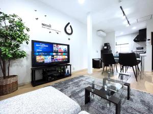 TV a/nebo společenská místnost v ubytování guesthouse Nakatsu