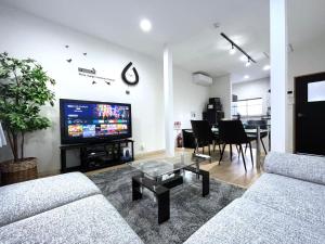 TV a/nebo společenská místnost v ubytování guesthouse Nakatsu