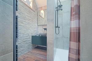 a bathroom with a shower with a sink and a mirror at La Ferme du Parc - Gite Le Fournil in Montignies-lez-Lens +19 photos