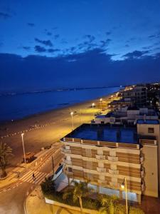 a building on a beach at night with the ocean at Sunset 8F in Santa Pola