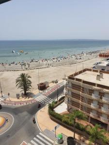a view of a beach with a building and the ocean at Sunset 8F in Santa Pola