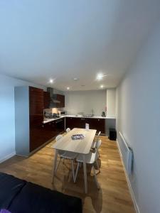 a dining room and kitchen with a table and chairs at Quayside Apartments in Cardiff