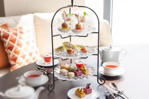 a tray of food on a table with cups of tea at ANA InterContinental Appi Kogen Resort, an IHG Hotel in Hachimantai
