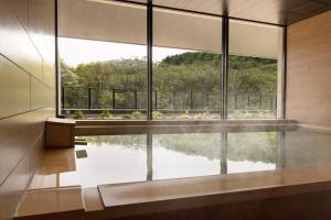 a room with a large window and a pool of water at ANA InterContinental Appi Kogen Resort, an IHG Hotel in Hachimantai