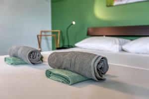 two rolled towels on a bed in a bedroom at 49/3 Seafront Duplex Penthouse in Valletta in Valletta +39 photos