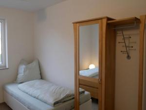 a small room with a mirror and a bunk bed at Ferienwohnung Haus Maria in Wäschenbeuren