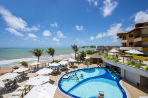 an aerial view of a resort with a swimming pool and the beach at Rifoles Praia Hotel e Resort in Natal