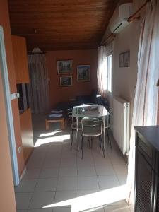 a kitchen with a table and chairs in a room at Xristina's sofita in Kozani