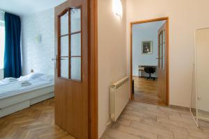 a room with a bed and a door leading to a bedroom at Wondrous Apartment Warszawska street in Krakow