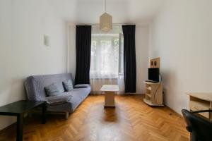 a living room with a couch and a table at Wondrous Apartment Warszawska street in Krakow