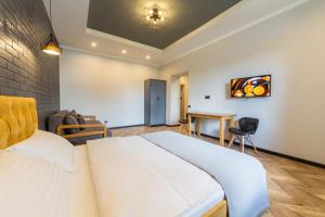 a bedroom with a large white bed and a desk at Self Check-in Apartments in Kyiv