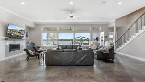 a large living room with a couch and a tv at Luxury Waterfront Pool Hot Tub Boat Slips in Kingsland