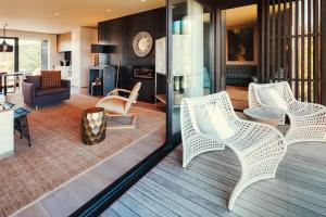 a living room with wicker chairs and a couch at Kinloch Manor & Villas in Kinloch