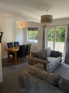 a living room with a couch and a table at Whole Apartment Near to London in Bromley