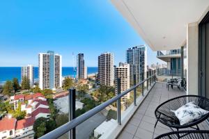a balcony with chairs and a view of the ocean at Romantic Getaway in Surfers Paradise - Elston Apartment with Ocean View - Wow Stay in Gold Coast
