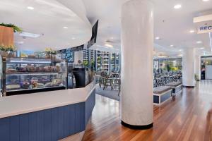 a restaurant with a white column in the middle at Romantic Getaway in Surfers Paradise - Elston Apartment with Ocean View - Wow Stay in Gold Coast