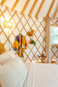 a room with a bed in a yurt at Camposanto Glamping - The Macaw Yurt in Austin