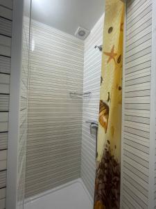 キーウにあるUneed Rooms Sakvoiajのバスルーム(ガラスドア付きのシャワー付)