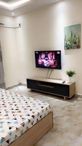 a living room with a flat screen tv on a wall at Residence Meublée Liberté 2 in Dakar