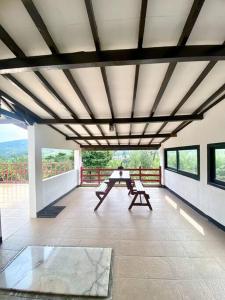 a room with a table on a balcony at Guest House Sakura F3 in Karangtengah
