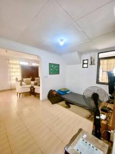 a living room with a couch and a bed in it at Guest House Sakura F3 in Karangtengah