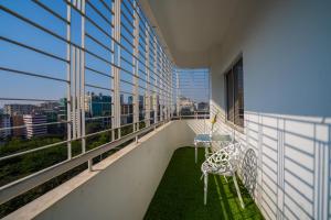 a balcony of a building with a table and chairs at Shinepukur Suites at Concord in Dhaka
