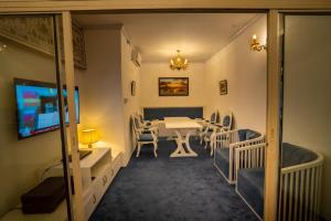 a dining room with a table and chairs and a television at Shinepukur Suites at Concord in Dhaka +20 photos