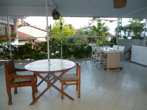 a patio with a table and chairs and an umbrella at Frankfurt Hotel in Antalya