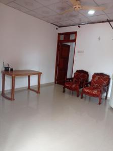a room with a table and two chairs and a table at Weligama Elite Guest in Weligama