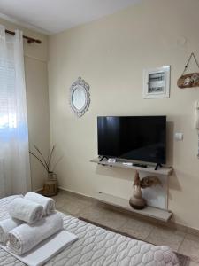 ein Wohnzimmer mit einem Flachbild-TV an der Wand in der Unterkunft Stergios_Apartments 02 in Kozani