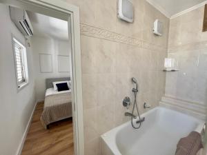 a bathroom with a shower and a bath tub at The Symphony of the Breeze in Netanya