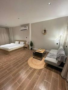 a room with a bed and a couch and a table at Al Hada Hills Residential Unit in Al Hada