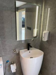 a bathroom with a white sink and a mirror at Al Hada Hills Residential Unit in Al Hada +18 photos