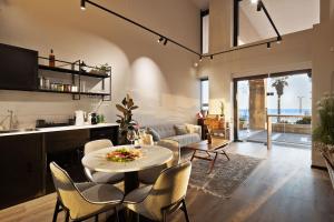 a kitchen and living room with a table and chairs at Samuel TLV in Tel Aviv