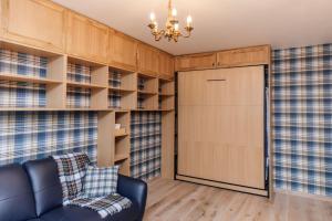 a living room with a couch and a sliding door at Studio design rénové/ Berges du Rhone in Lyon