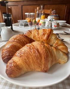 two croissants on a white plate on a table at Soupiets in Betpouey