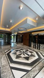 a lobby with a tile floor and a building at Apartament GJ PLAZA in Kielce