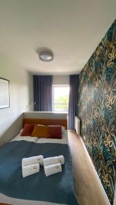 מיטה או מיטות בחדר ב-Apartament GJ PLAZA