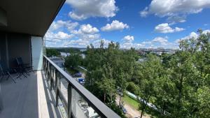 a balcony with a view of trees and a city at Apartament GJ PLAZA in Kielce