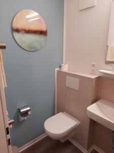 a bathroom with a toilet and a sink at Altdeutscher Hof Beckord in Gütersloh